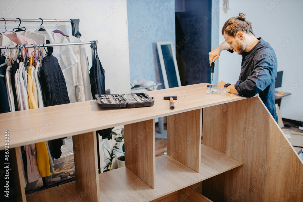 man assembling furniture wooden cabinet at home man assembling furniture wooden cabinet at home