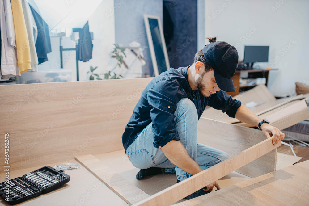 man assembling furniture wooden cabinet at home man assembling furniture wooden cabinet at home