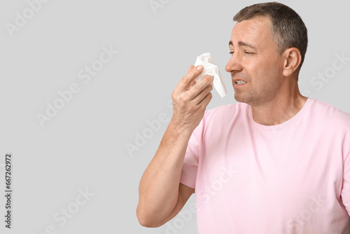 Ill mature man with tissue ...