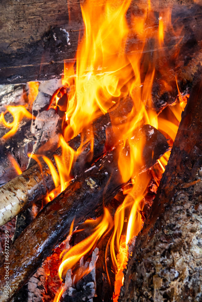 Vibrant bonfire with high, flickering red flames in night setting. Vibrant bonfire with high, flickering red flames in night setting.