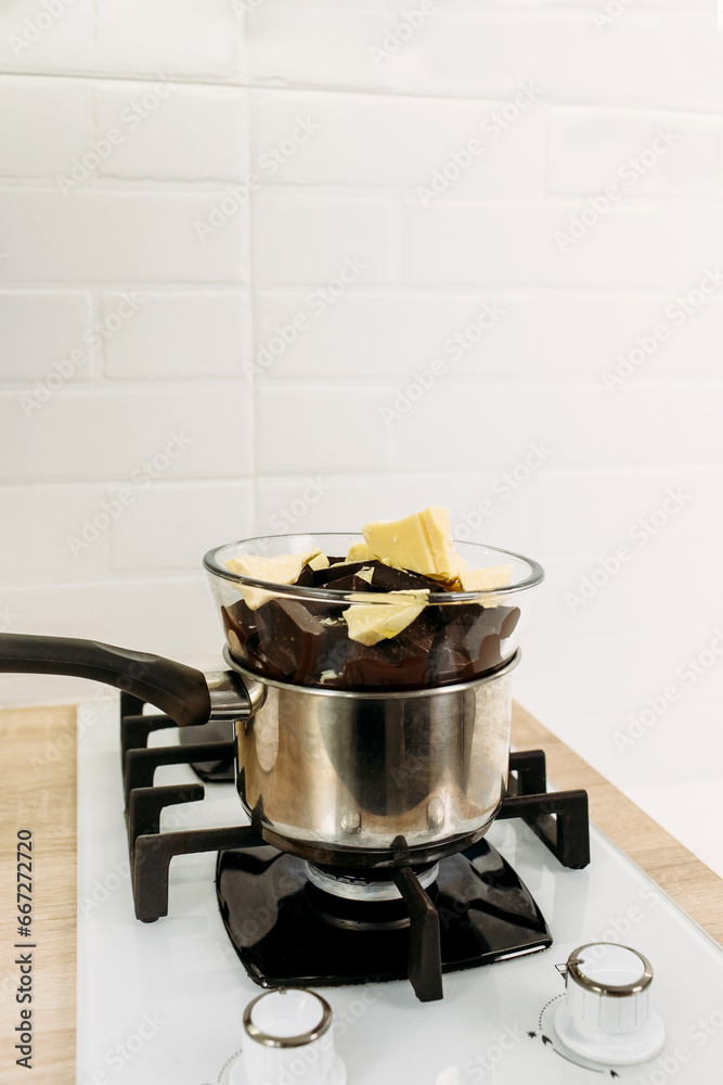 Chocolate and cocoa butter melt in steam in a plate. Chocolate and cocoa butter melt in steam in a plate.