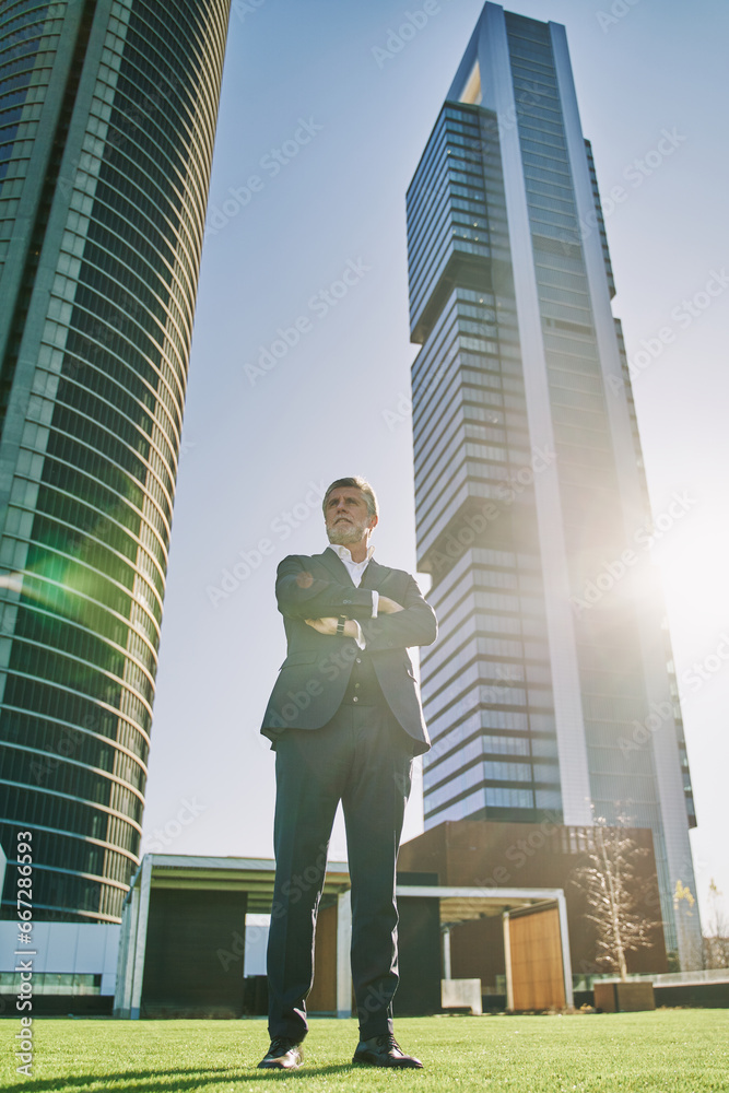 middle-aged white-haired and gray-haired man posing full-length on office background middle-aged white-haired and gray-haired man posing full-length on office background