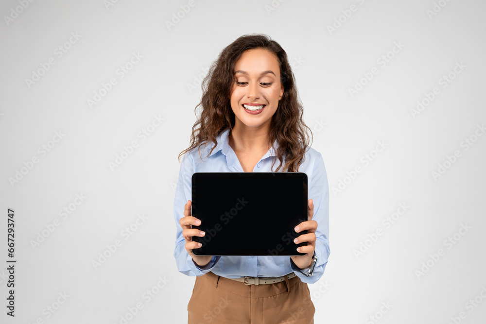 Positive european young woman professional show tablet with empty space Positive european young woman professional show tablet with empty space