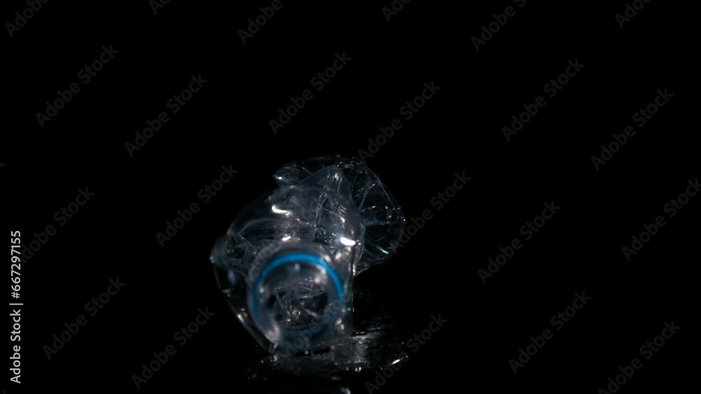 Plastic bottle on a black background. Plastic pollution concept. Plastic bottle on a black background. Plastic pollution concept.