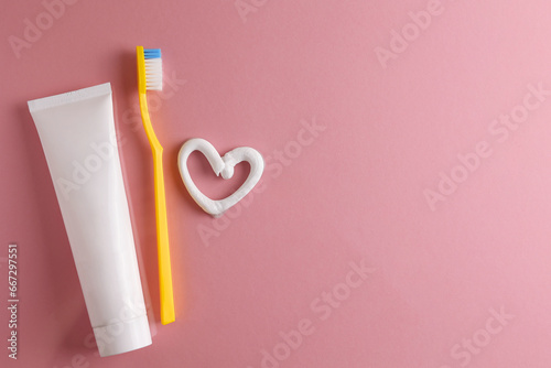 Toothpaste heart on a colored background. Dental care, oral health. photo