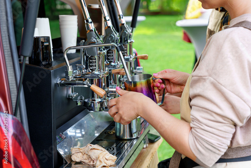 Barista Making Tasty Coffee on a Professional Machine Installed in the Backside of a Minivan: Food Service, Best Coffee, and Events Outdoors