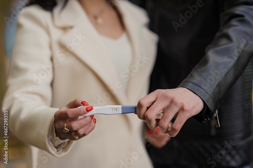 Woman with a positive pregnancy test. Girl holding a pregnancy test in her hands