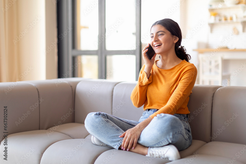 Portrait Of Beautiful Young Indian Woman Talking On Mobile Phone At Home Portrait Of Beautiful Young Indian Woman Talking On Mobile Phone At Home