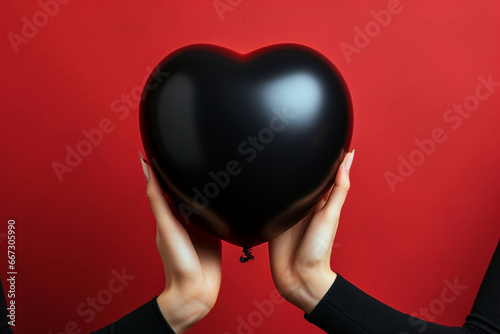 Two hands holding black heart shaped balloon, Anti Valentine's love celebration banner. Card, party, design, flyer, poster, banner, web, advertising.