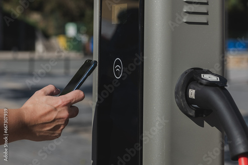 Anonymous person trying wireless EV charging connectivity