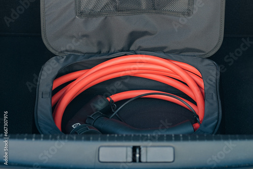 Electric vehicle charging cable in trunk photo