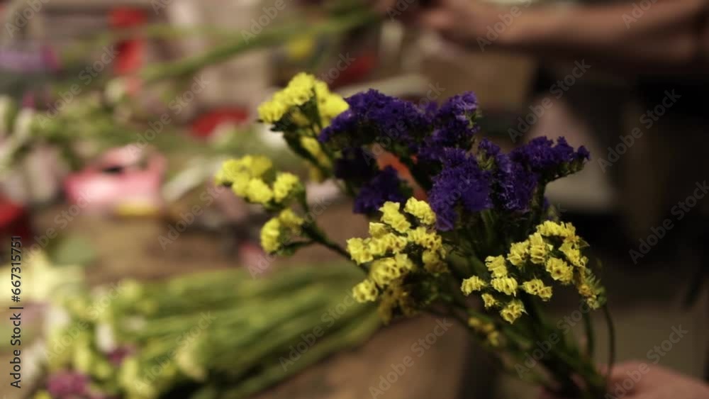 Florist making bouquet of flowers in flower shop in Lviv Florist making bouquet of flowers in flower shop in Lviv