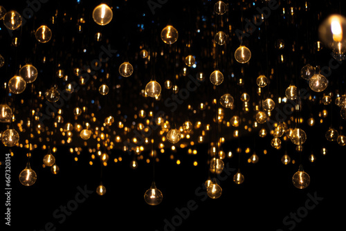 Gold Twinkle Christmas string lights on black background. photo