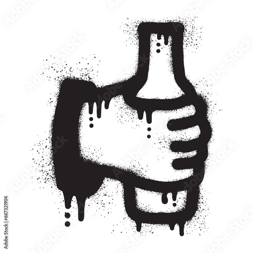 hand holding a bottle with black spray paint
