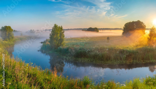 panorama of a summer landscape with sunrise fog and the river