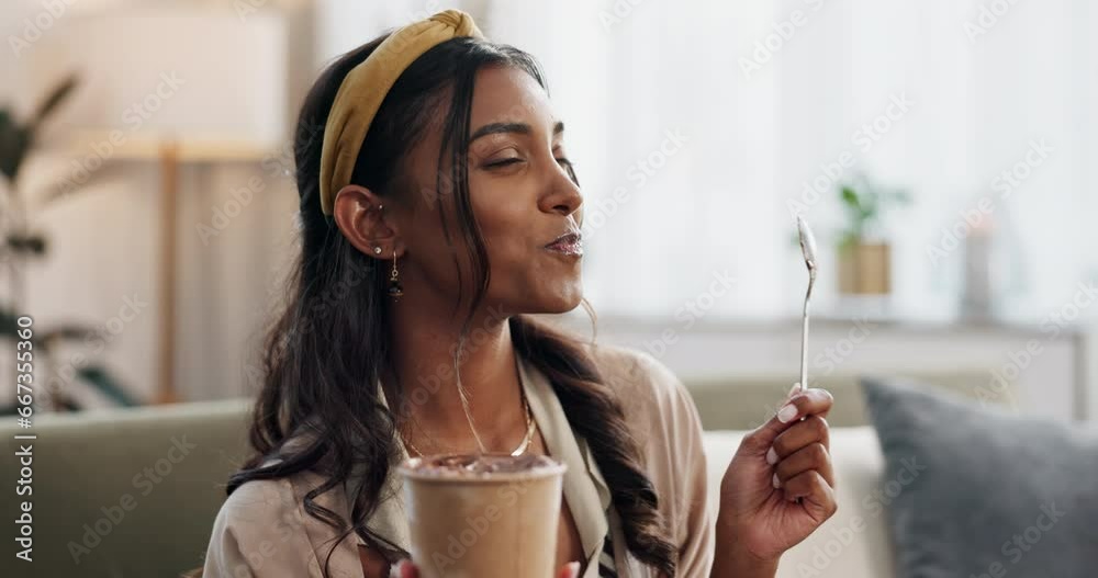 Woman, eating chocolate ice cream and sofa with happiness, gen z aesthetic and relax weekend in living room. Young, indian person and smile by dessert in excited, sweet tooth and sugar candy at home