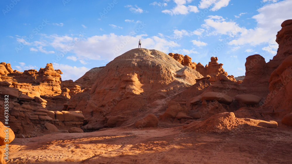 Hiker standing on a hill at Goblin Valley in Utah, USA