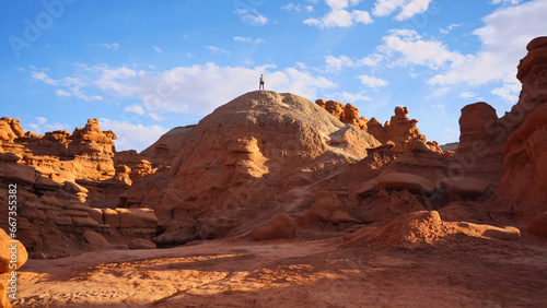 Hiker standing on a hill at Goblin Valley in Utah  USA