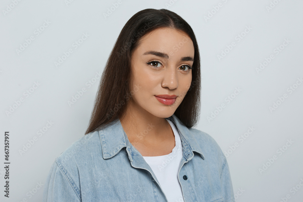 Portrait of beautiful young woman in jeans jacket on white background Portrait of beautiful young woman in jeans jacket on white background