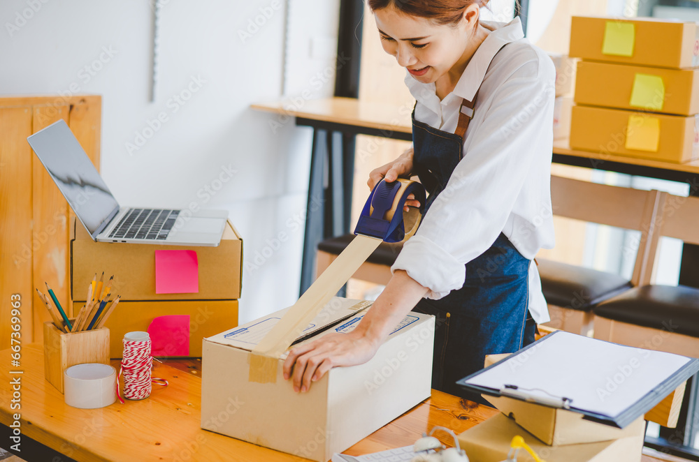 Online small business owners are packing their ordered products into the boxes for their customers based on the concept of online shopping - online shopping. Online small business owners are packing their ordered products into the boxes for their customers based on the concept of online shopping - online shopping.