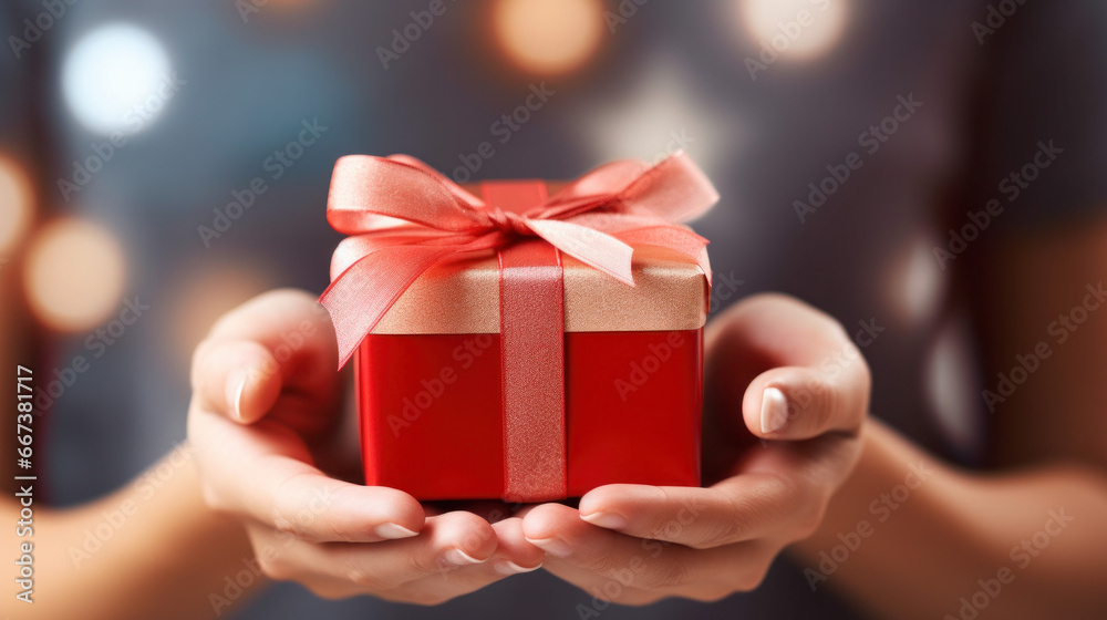 Hand holding wrapped gift box