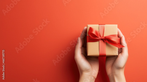 Hand holding wrapped gift box photo