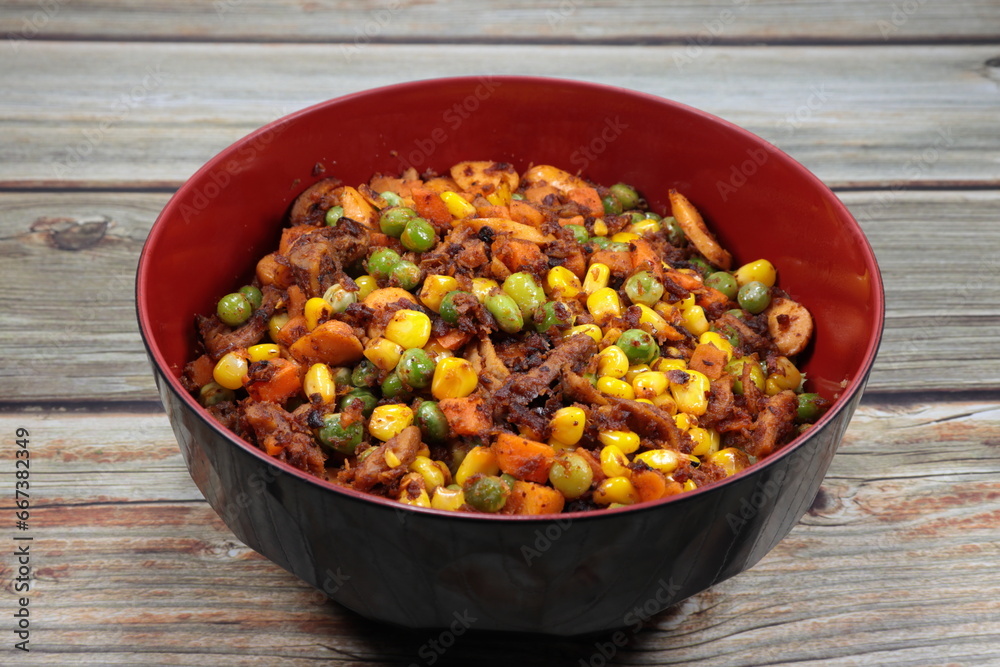 Spicy vegetarian salad with mixed grain, sweet corn, carrot and mushroom serving in the bowl. Famous appetizer menu in Asian restaurant. Spicy vegetarian salad with mixed grain, sweet corn, carrot and mushroom serving in the bowl. Famous appetizer menu in Asian restaurant.