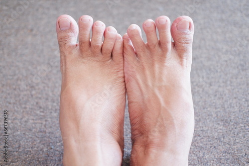 Close up of human foot on the floor, shallow depth of field photo