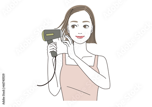 ドライヤーで髪の毛を乾かしている笑顔の女性