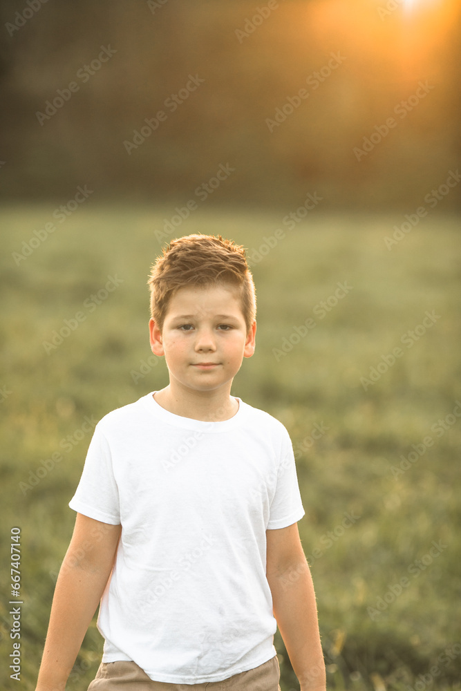 Upset little American boy looks at camera with confused face stands outside. Disappointed caucasian preschooler puzzled. Upset little American boy looks at camera with confused face stands outside. Disappointed caucasian preschooler puzzled.