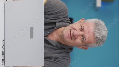 Vertical video of Home office worker man talking motivationally to camera. photo