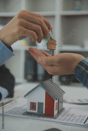 Real estate agent and customer signing contract to buy house, insurance or loan real estate.rent a house,get insurance or loan real estate or property.