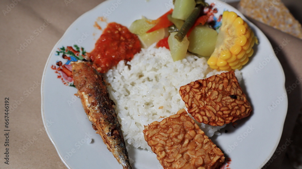 white rice with side dishes of fried salted fish and tamarind vegetables