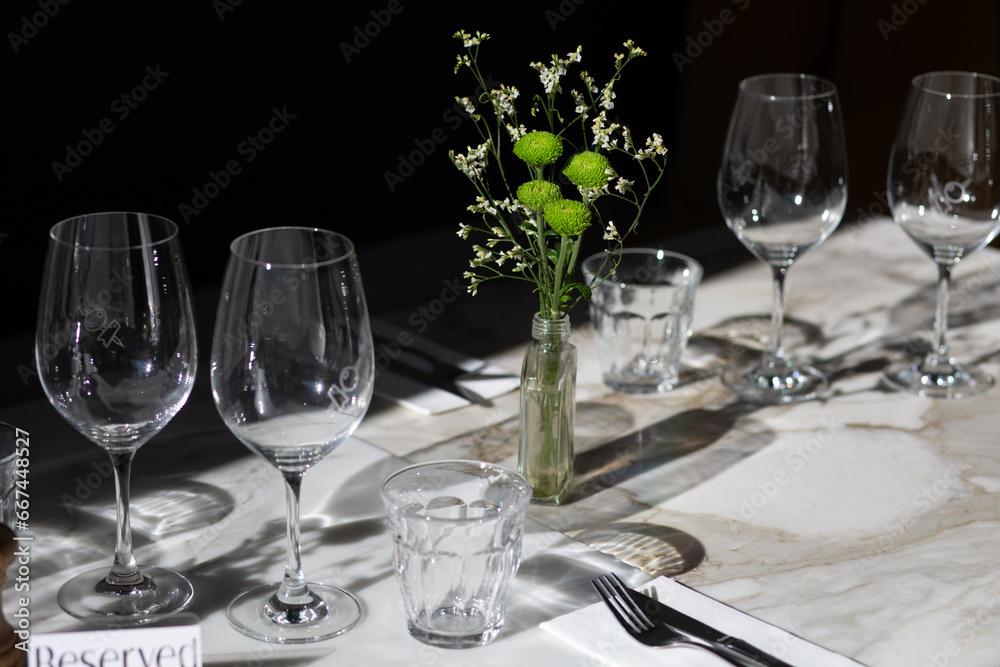 Wineglasses and flowers in a table setting. Wineglasses and flowers in a table setting.