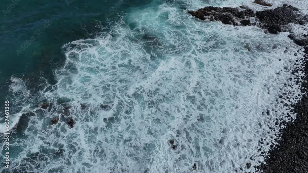 Aerial Kauai Hawaii beautiful coastal rocky surf waves. Economy is tourism based water, tropical beach recreation and fun. Beautiful clear blue ocean sea. Tropical warm climate. Aerial Kauai Hawaii beautiful coastal rocky surf waves. Economy is tourism based water, tropical beach recreation and fun. Beautiful clear blue ocean sea. Tropical warm climate.