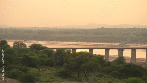 Pan shot of an old abandoned bridge on Chambal river during sunset in Dholpur India photo