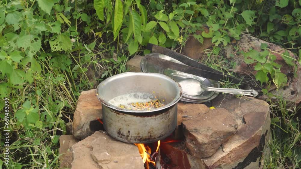 Cooking Dal curry or Pulses an Indian dish in outdoor picnic in India Cooking Dal curry or Pulses an Indian dish in outdoor picnic in India