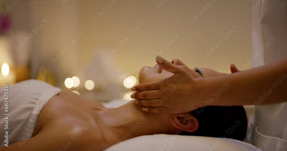 Relax, skincare and woman with facial massage at spa in zen, physical therapy on bed with candles at resort. Face of calm female person sleep in rest with body care for health and wellness at salon.