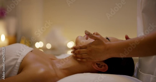 Relax, skincare and woman with facial massage at spa in zen, physical therapy on bed with candles at resort. Face of calm female person sleep in rest with body care for health and wellness at salon. photo