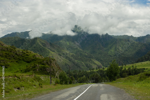 Empty asphalt road in mountains, beautiful landscape of Altay, nature light, road trip in Altai