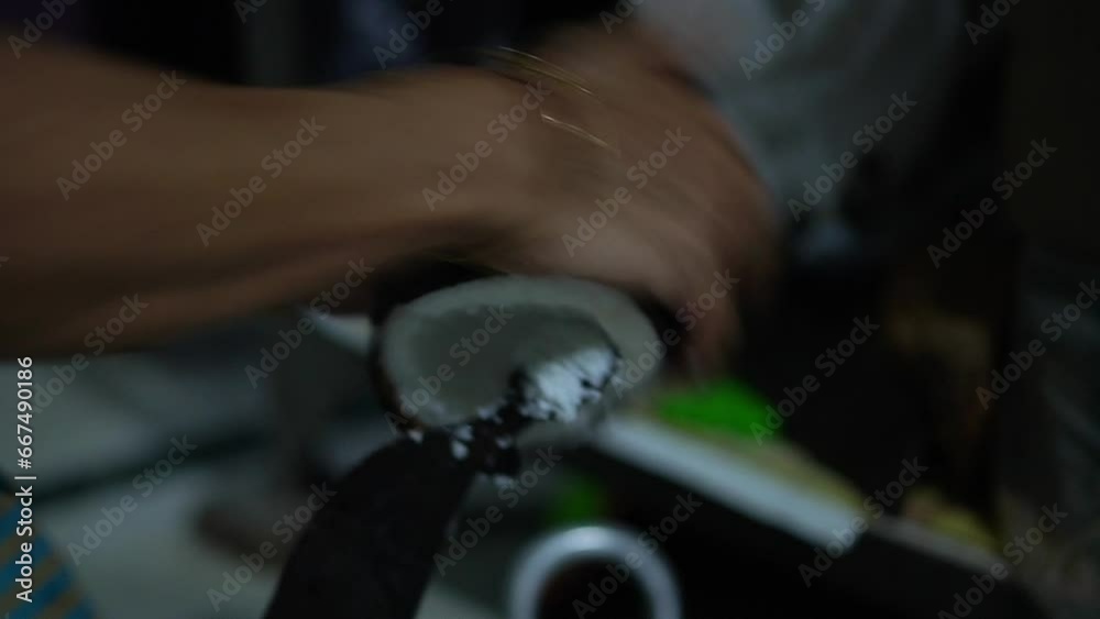 close up video clip of coconut grating manually by hand in home of India close up video clip of coconut grating manually by hand in home of India
