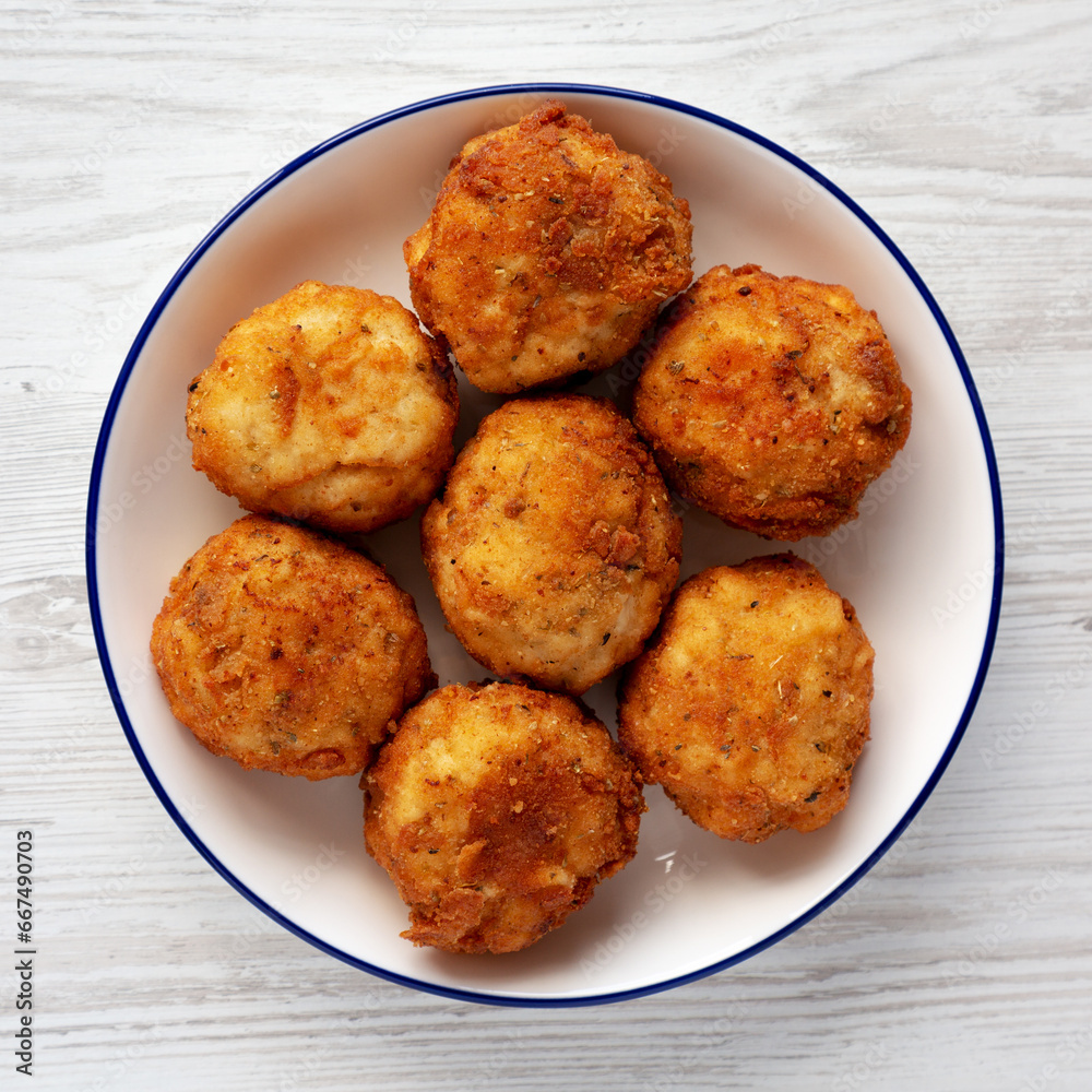 Homemade Cheesy Chicken Nuggets on a Plate, top view. Overhead, from above, flat lay. Homemade Cheesy Chicken Nuggets on a Plate, top view. Overhead, from above, flat lay.
