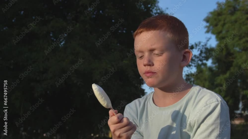 red boy eating popsicle