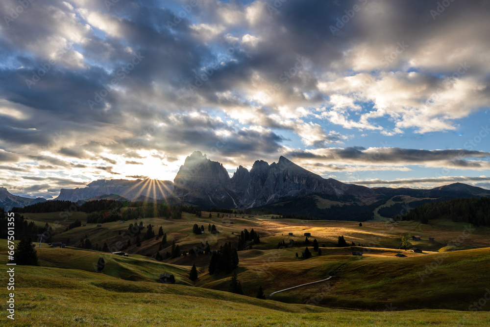 The Sunrise with a beautiful sun on Alps di siu si and the cloudy sky on Dolomites region , Italy