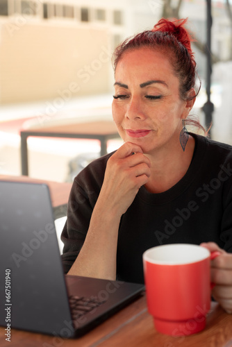 old latin woman using laptop to shop online, mature woman technology concept