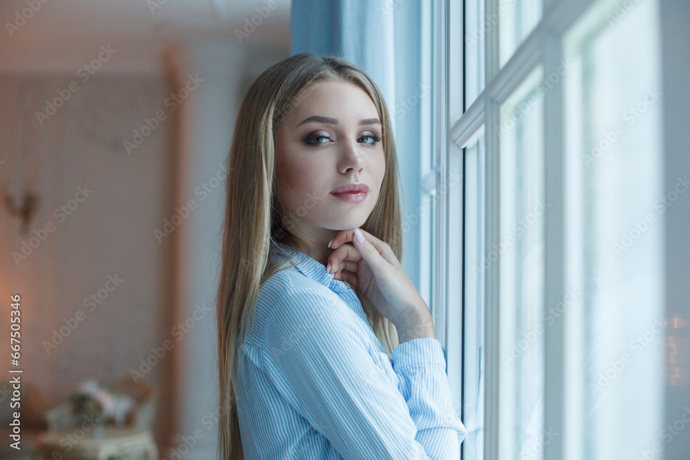 Portrait of perfect young blonde woman at home