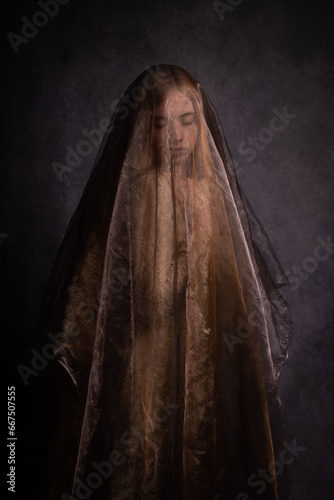 solemn art portrait of woman  under golden veil in renaissance style photo