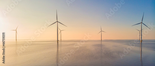 Windmill park in the ocean, drone aerial view of windmill turbines generating green energy electric