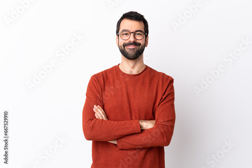 Caucasian handsome man with beard over isolated white background keeping the arms crossed in frontal position photo