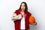 Young caucasian woman playing basketball isolated on white background surprised and shocked while looking right